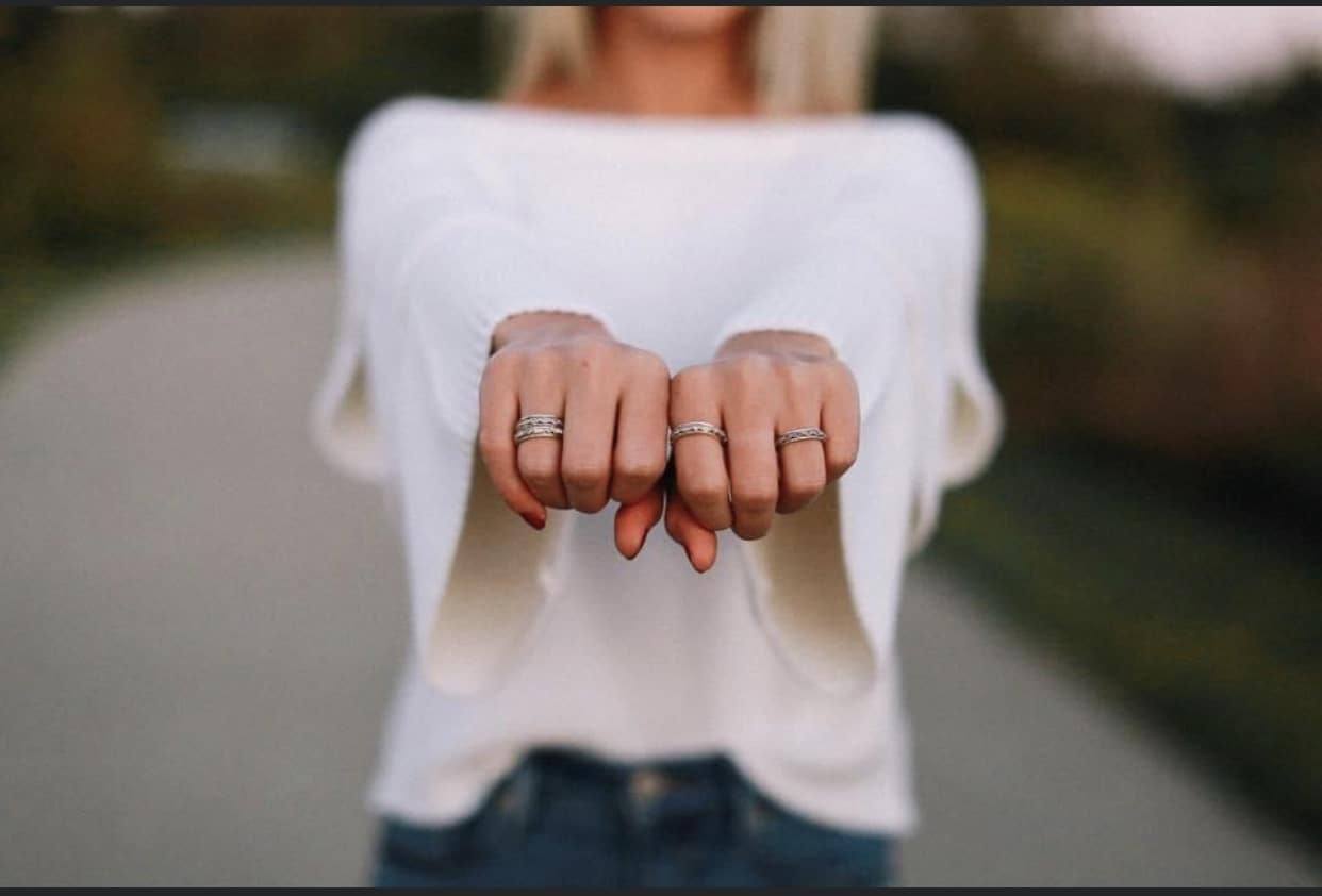 designer jewelry on two hands