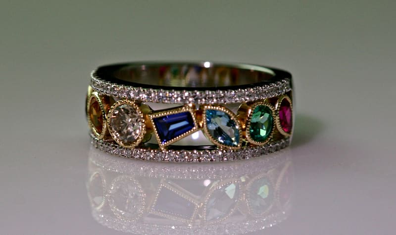 A custom band set with diamonds and colored gemstones