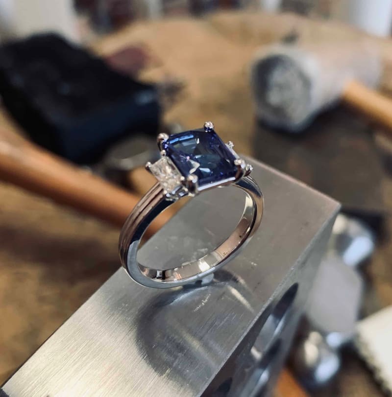 A sapphire and diamond ring on the bench block in Godfrey's workshop